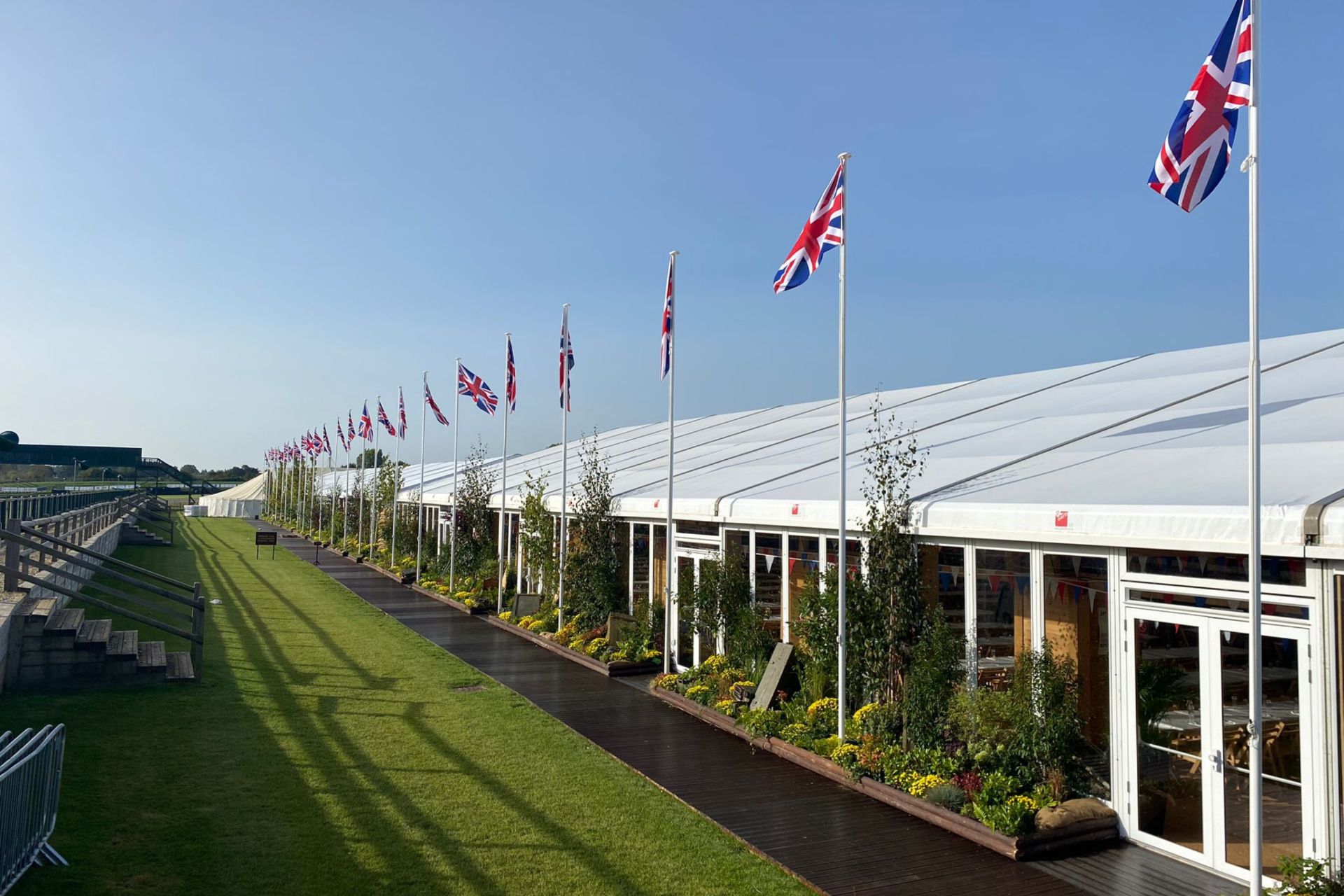 long run of decking and planting to a temporary event structure