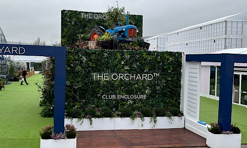 Cheltenham Festival the orchard entrance with artificial wall panels and tractor on roof
