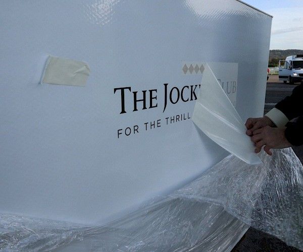trough branding with jockey club logo on