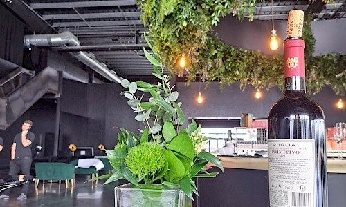 JLR Retailer of the Year small green poseur table display with hanging feature in background