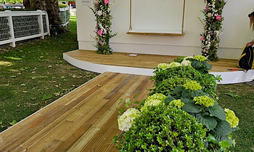 Royal Ascot planted archway with swing and pink floral