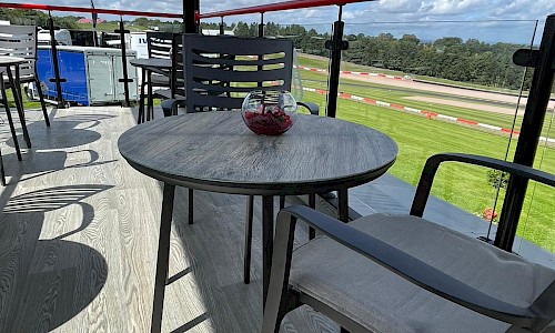 Renault- Shipping Container Unit top deck with grey metal table and chairs with red floral table center