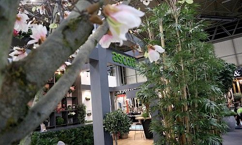 January Furniture Show artificial blossom tree on exhibition stand close up